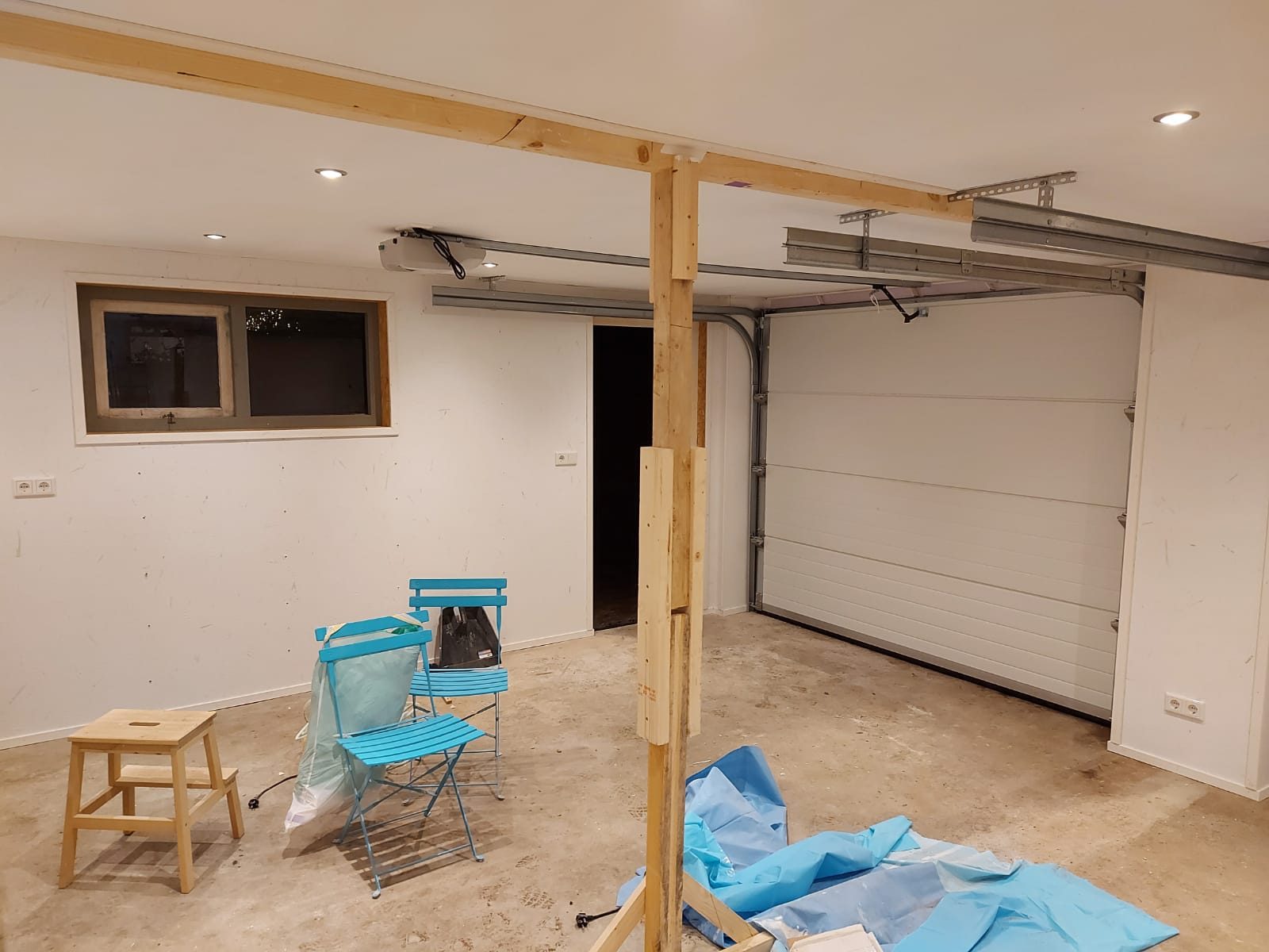 Vernieuwde ruimte met garagedeur tijdens de afronding van een verbouwing in Haren